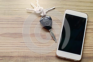 Smart phone with blank screen and car remote alarm control key on the table