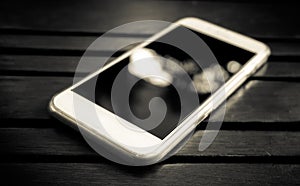 Smart phone with blank screen lying on table