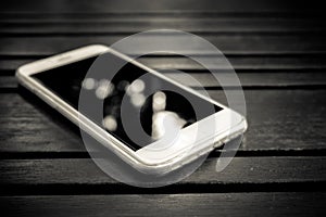 Smart phone with blank screen lying on table