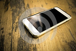 Smart phone with blank screen lying on table