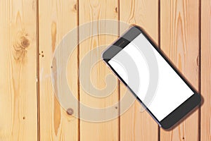 Smart phone with blank screen on wooden table background with co