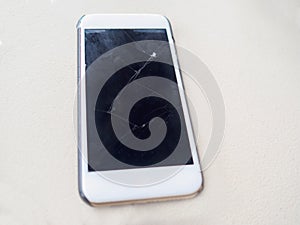 Smart phone with broken, cracked, screen, on white background.