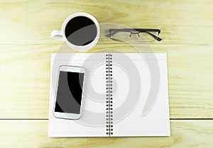 Smart phone, coffee,glasses and book blank on wood table background.