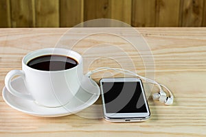 Smart phone and coffee on wooden table