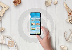 Smart phone on desk with travel destinations app. Plan a trip concept