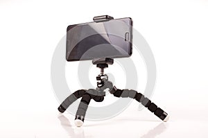 Smart phone with flexible tripod  on the white background