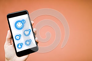 The smart phone on the human hands with social network icons