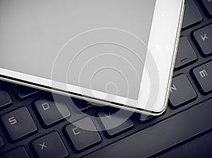 Smart Phone On Keyboard Close Up