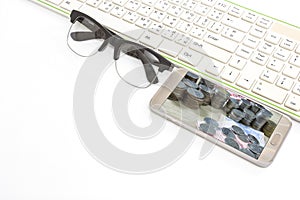 Smart phone and keyboard and glasses on white background,business concept