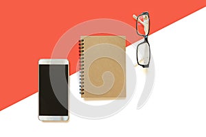 Smart phone, note book, eye glasses on red and white background