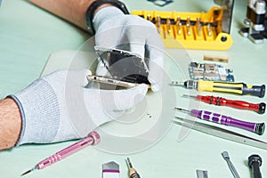 Smart phone repair. repairman disassembling smartphone