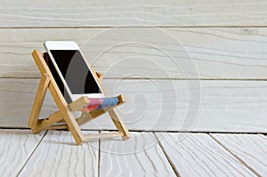 Smart phone on wooden table background with copy space