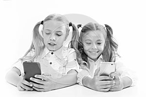 Smart pupils. Little pupils texting message during class isolated on white. Cute lyceum pupils diving deep into