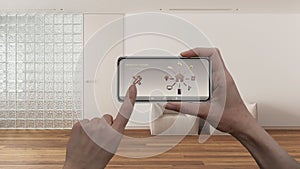 Smart remote home control system on a smart phone. Device with app icons. Interior of sitting waiting room with glass brick wall