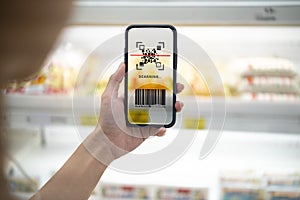 Smart retail concept.Female hands using barcode scan for information of product in supermarket