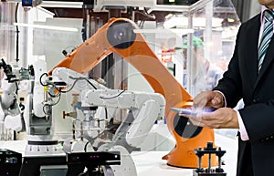 Smart robot replacement Industrial 4.0 of things technology robot future arm and man using controller