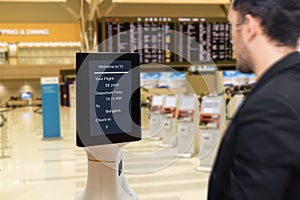 Smart robotic technology concept, The passenger follow a service robot to a counter check in in airport, the robot can help and gi