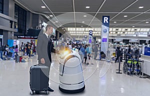 Smart robotic technology concept, The passenger follow a service robot to a counter check in in airport, the robot can help and gi