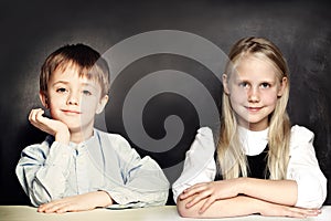 Smart school children girl and boy on blackboard background