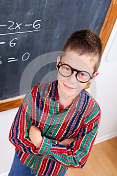 Smart schoolboy at chalkboard