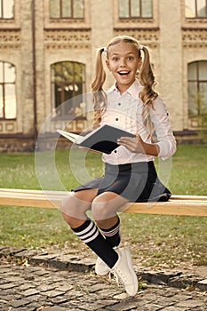 Smart schoolgirl. Schoolgirl reading book. Little genius. Schoolgirl relaxing sit bench with book. Time to study