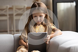 Smart small girl use tablet at home