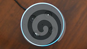 Smart speaker top view artificial intelligence assistant voice control blue ring button activation