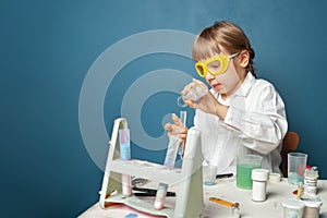 Smart student child girl doing science experiment at entertainment center