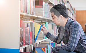 Smart student find book on bookshelf in library