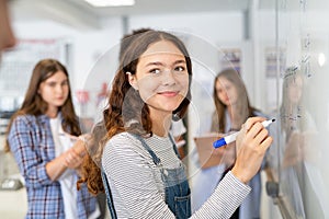 Smart student girl writing on whiteboard