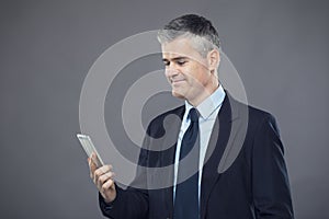 Smart successful businessman texting a message