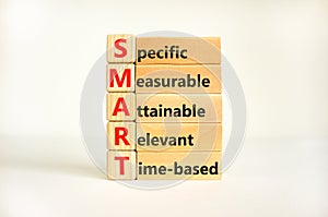 SMART symbol. Concept words SMART specific measurable attainable relevant time-based on block. Beautiful white background.