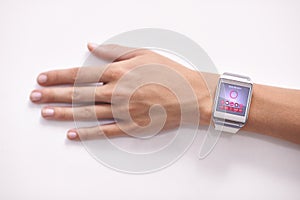 Smart technology. Closeup studio shot of a womans arm wearing a smartwatch - All screen content is designed by us and