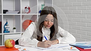 smart teen girl writing in notebook with pen, school time