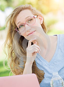 Smart Teen Student Wearing Glasses Outdoors Using Her Laptop.