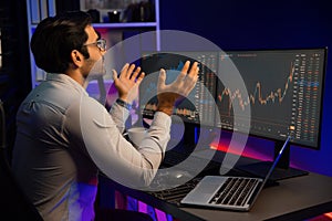 Smart trader concentrating on dynamic stock exchange on pc and laptop. Surmise.