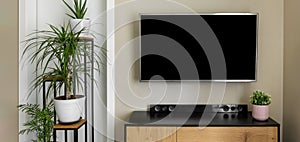 smart tv mockup hanging on beige wall in modern interior with green plants