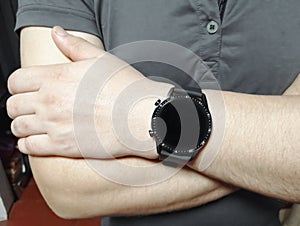 Smart watch on the hand of a man. Men's watch on the arm. A man with a watch on his arm. Huawei smart watch photo