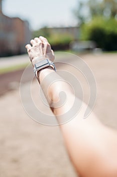 Smart watch on sporting girl wrist. Smart watch health, heart rate and fat burn monitoring. Jogging goals preparation. Lifestyle