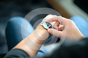 Smart watch, wearable gadget. Man wearing hybrid smartwatch. Wearables with digital touchscreen and mobile app technology.