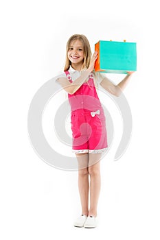 Smart ways to save on clothing. Girl cute teenager carries shopping bag. Kid bought clothing sale. Loyalty program helps