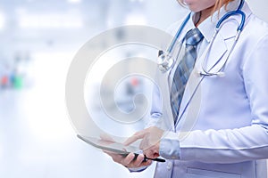 Smart woman doctor holding tablet and pointing to screen