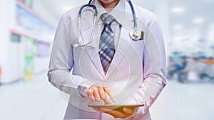 Smart woman doctor holding tablet and pointing to screen