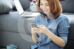 Smart Woman Explore Online Shopping Website on smartphone. Smiling face of asian woman holding cellphone with E-commerce Shopping