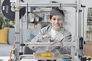 Smart boy using a 3D printer at home