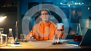 Smart Young Boy in Safety Goggles Mixes Colorful Chemicals in Beakers at Home. Teenager Conducting