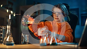 Smart Young Boy in Safety Goggles Mixes Colorful Chemicals in Beakers at Home. Teenager Conducting