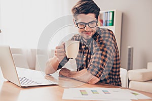 Smart young businessman drinking coffee and reading diagrama photo