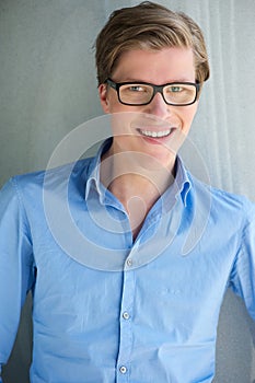 Smart young man smiling with glasses