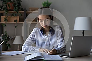 Smart young woman handwrite study distant at home